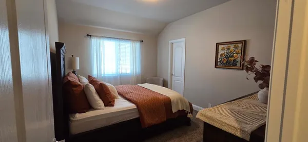 a bedroom with a bed and a couch