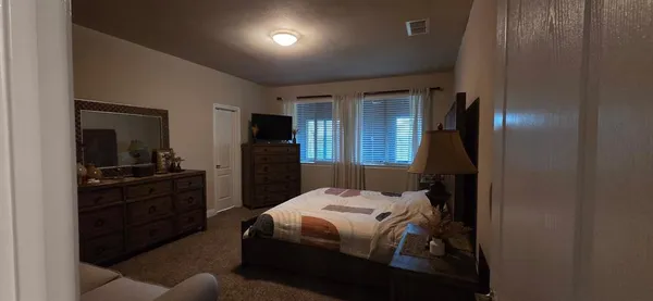 a bedroom with a bed and a dresser