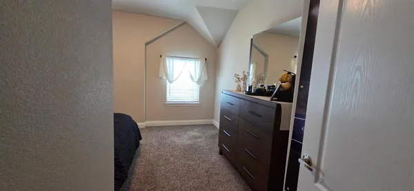 a view of a hallway and a livingroom with furniture