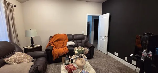 a living room with furniture and a lamp