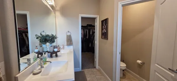 a bathroom with a double vanity sink and a mirror
