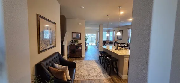 a view of a hallway with furniture and windows