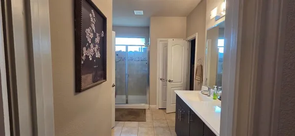 a view of walk in closet with clothes