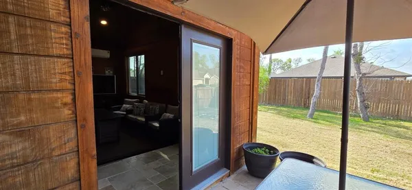 a living room with furniture tv and large windows
