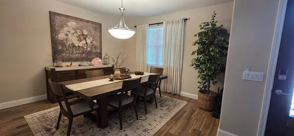 a view of a dining room with furniture and window