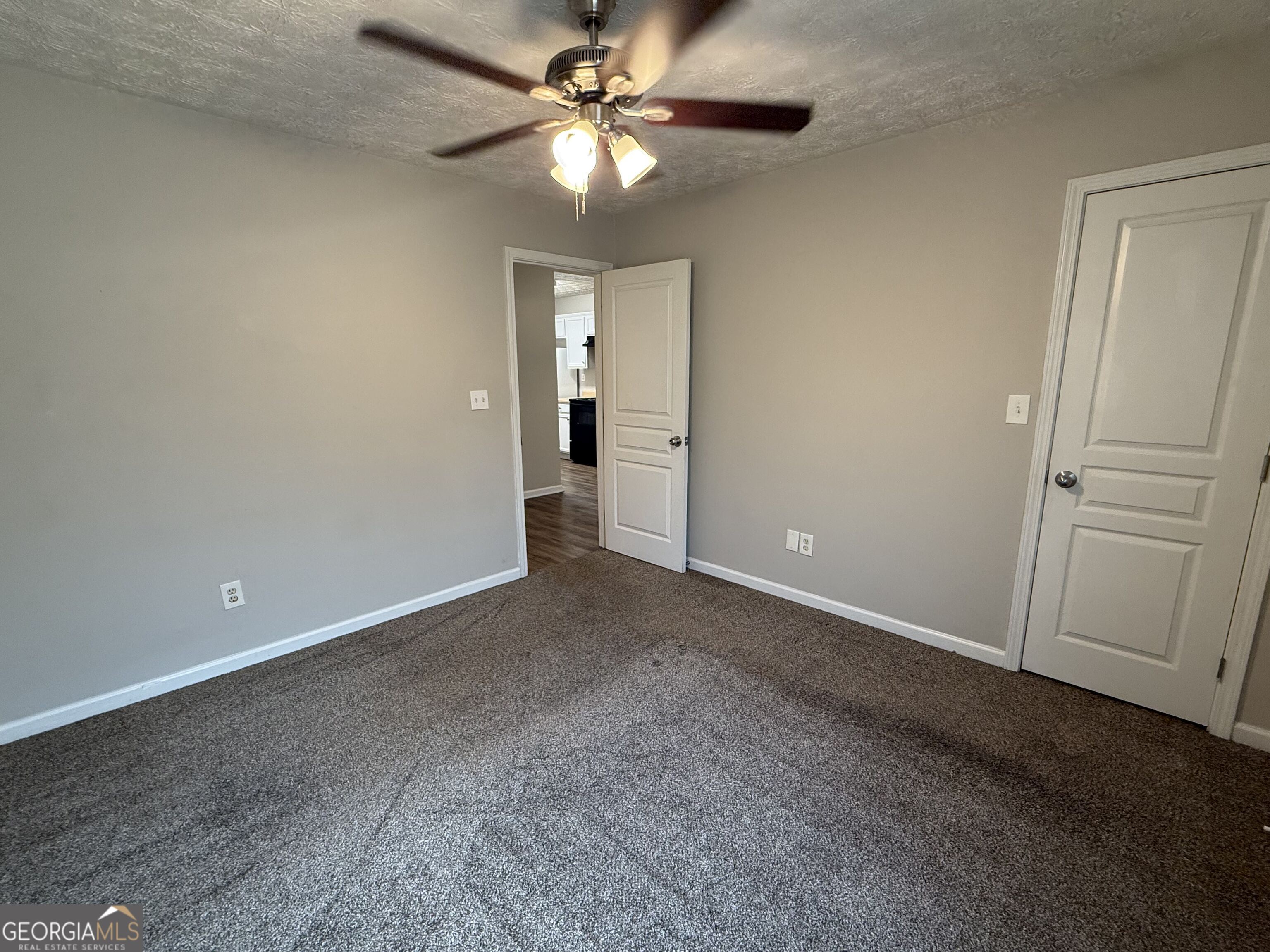 6132 Ruth Street Southwest Covington, GA 30014 - Photo 16 of 33 an empty room with closet and a ceiling fan