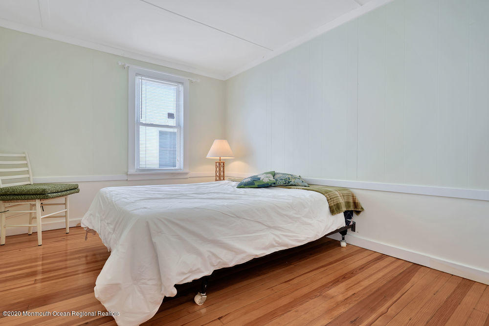 292 N Street, Unit A1 Seaside Park, NJ 08752 - Photo 11 of 31 a bedroom with a bed and wooden floor