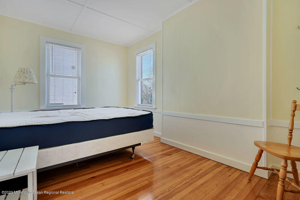 292 N Street, Unit A1 Seaside Park, NJ 08752 - Photo 13 of 31 a view of room with wooden floor and chair