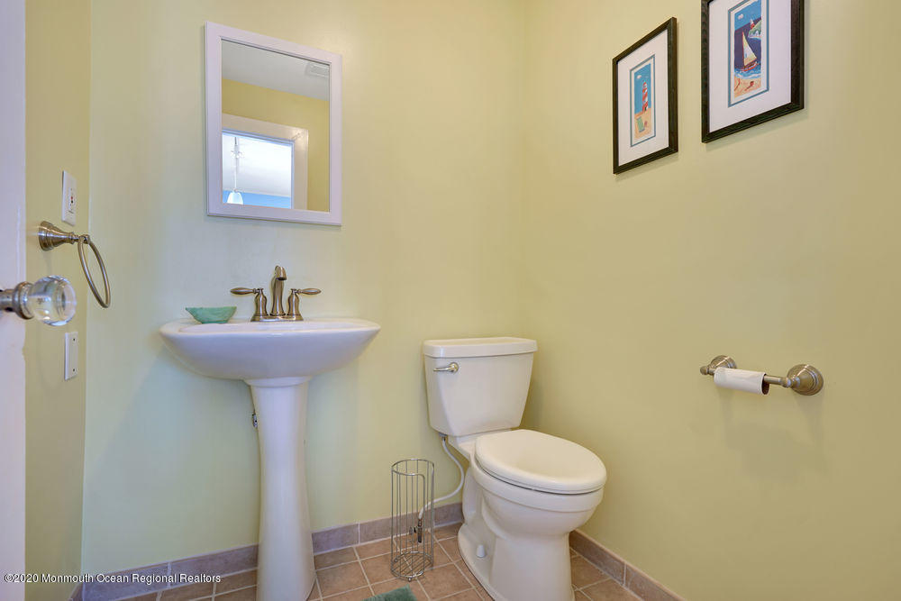 292 N Street, Unit A1 Seaside Park, NJ 08752 - Photo 14 of 31 a bathroom with a toilet sink and mirror