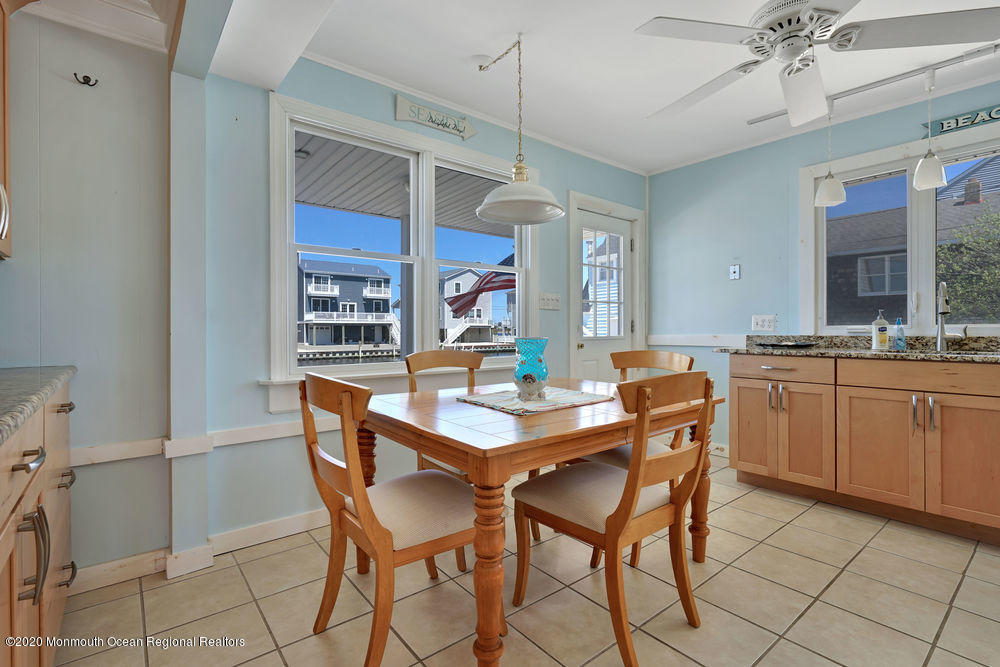292 N Street, Unit A1 Seaside Park, NJ 08752 - Photo 15 of 31 a dining room with a wooden table and chairs
