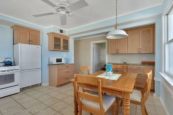 a living room with granite countertop furniture a dining table and chairs with wooden floor