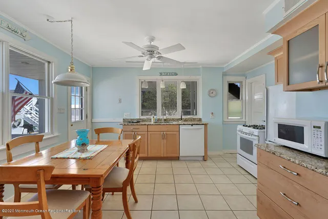 a kitchen with granite countertop cabinets stainless steel appliances and a sink