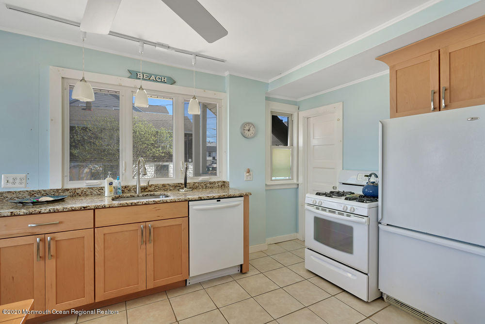 292 N Street, Unit A1 Seaside Park, NJ 08752 - Photo 20 of 31 a kitchen with granite countertop cabinets stainless steel appliances and a sink