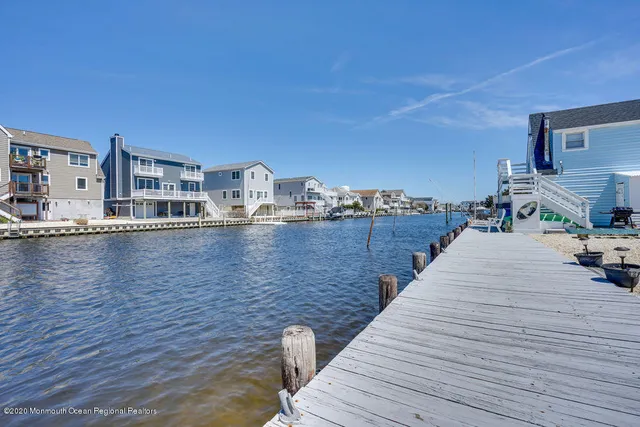 a view of a kitchen with a sink and living area