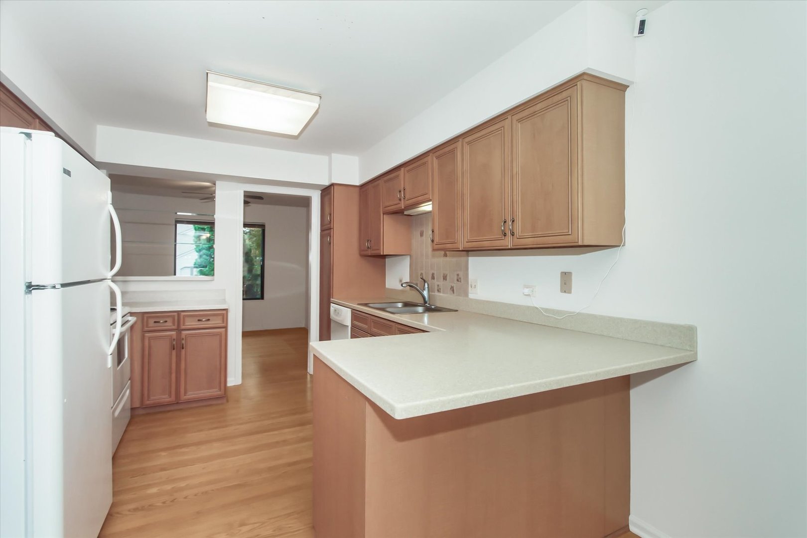 928 Longmeadow Court, Unit 1016 Barrington, IL 60010 - Photo 7 of 32 a kitchen with a sink cabinets and refrigerator