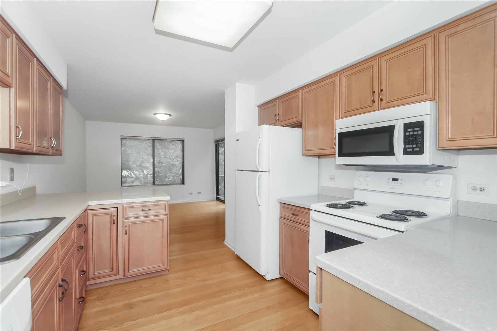 928 Longmeadow Court, Unit 1016 Barrington, IL 60010 - Photo 10 of 32 a kitchen with stainless steel appliances a stove a sink and a refrigerator