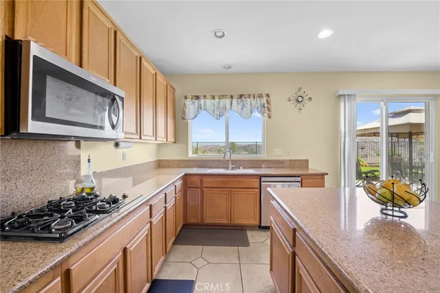 a living room with furniture fireplace and a large window