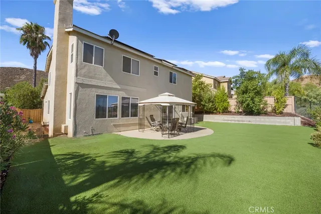 an aerial view of residential houses with outdoor space and trees