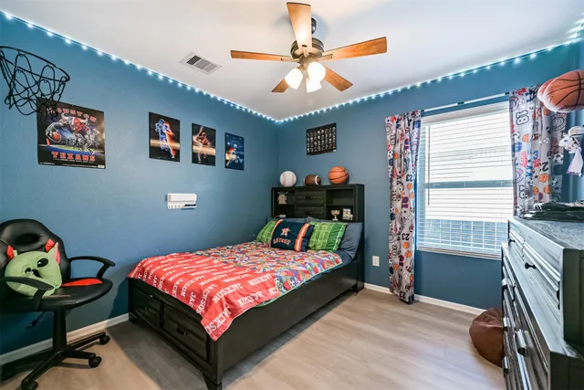 a bedroom with a bed and a chandelier