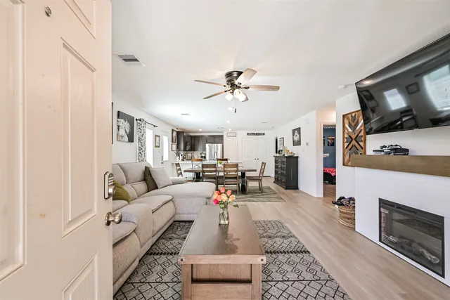 a living room with furniture fireplace and flat screen tv