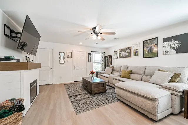 a living room with furniture and a fireplace