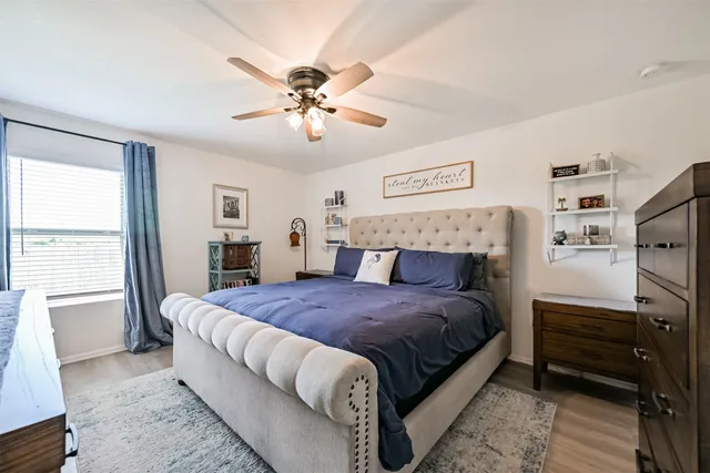 a bedroom with a bed and a chandelier