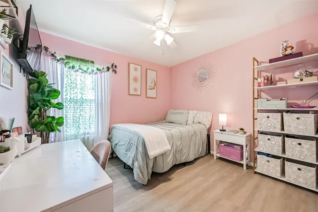 a bedroom with a bed dresser and a window