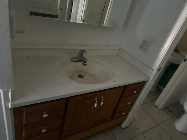 a bathroom with a sink and mirror