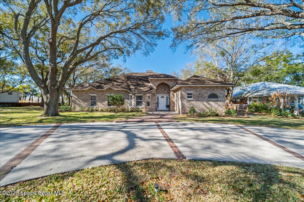 35 River Ridge Drive Rockledge, FL 32955 - Photo 1 of 48 a view of a large house with large trees and cars parked