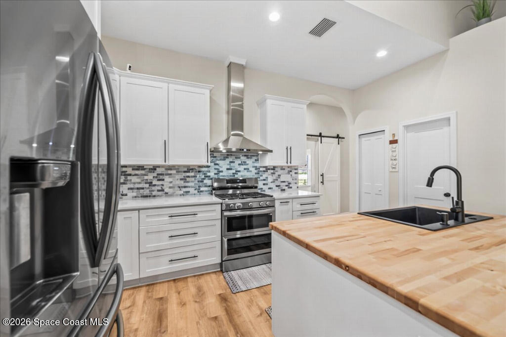 35 River Ridge Drive Rockledge, FL 32955 - Photo 11 of 48 a kitchen with kitchen island stainless steel appliances a sink stove and refrigerator