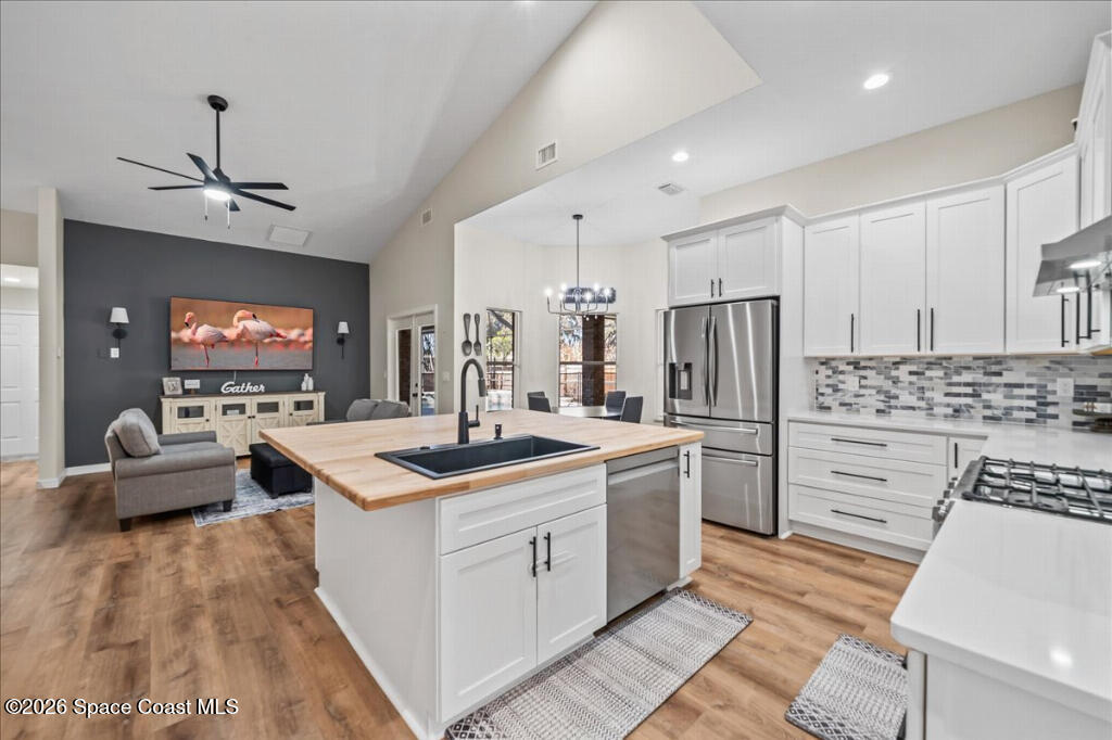 35 River Ridge Drive Rockledge, FL 32955 - Photo 12 of 48 a kitchen with stainless steel appliances granite countertop a sink stove and refrigerator