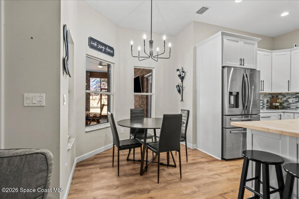 35 River Ridge Drive Rockledge, FL 32955 - Photo 13 of 48 a view of a dining room with furniture and chandelier