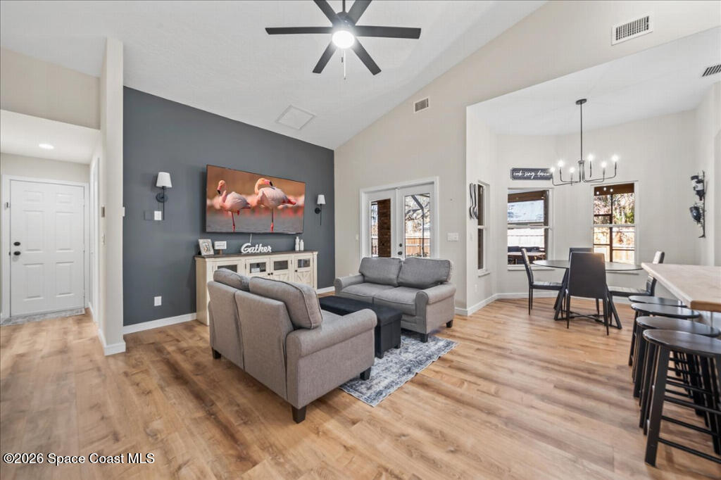 35 River Ridge Drive Rockledge, FL 32955 - Photo 14 of 48 a living room with furniture kitchen view and a wooden floor