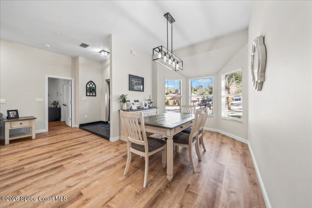 35 River Ridge Drive Rockledge, FL 32955 - Photo 15 of 48 a view of a dining room with furniture and wooden floor