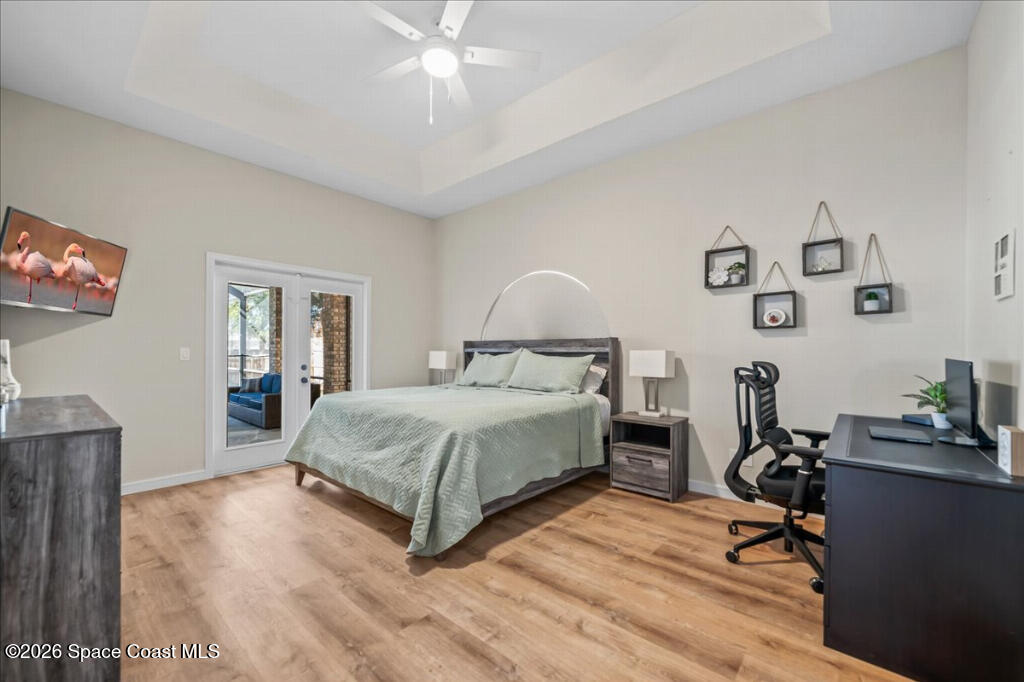 35 River Ridge Drive Rockledge, FL 32955 - Photo 17 of 48 a bedroom with a bed and wooden floor