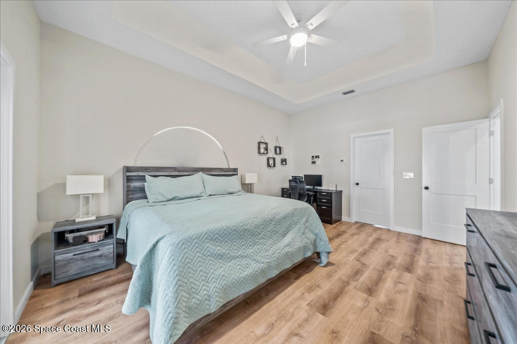 35 River Ridge Drive Rockledge, FL 32955 - Photo 18 of 48 a bedroom with a bed and a chandelier