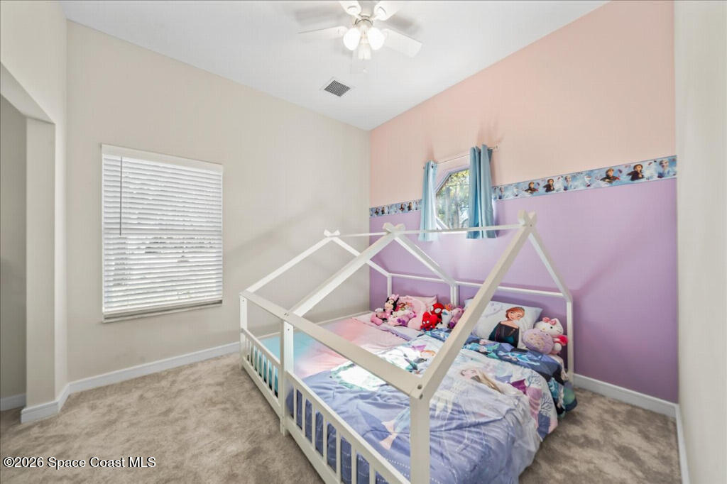 35 River Ridge Drive Rockledge, FL 32955 - Photo 19 of 48 a bedroom with furniture and a chandelier