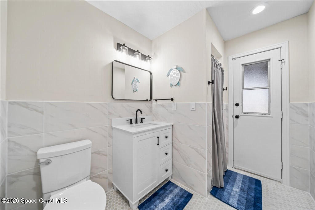 35 River Ridge Drive Rockledge, FL 32955 - Photo 25 of 48 a bathroom with a toilet sink and mirror
