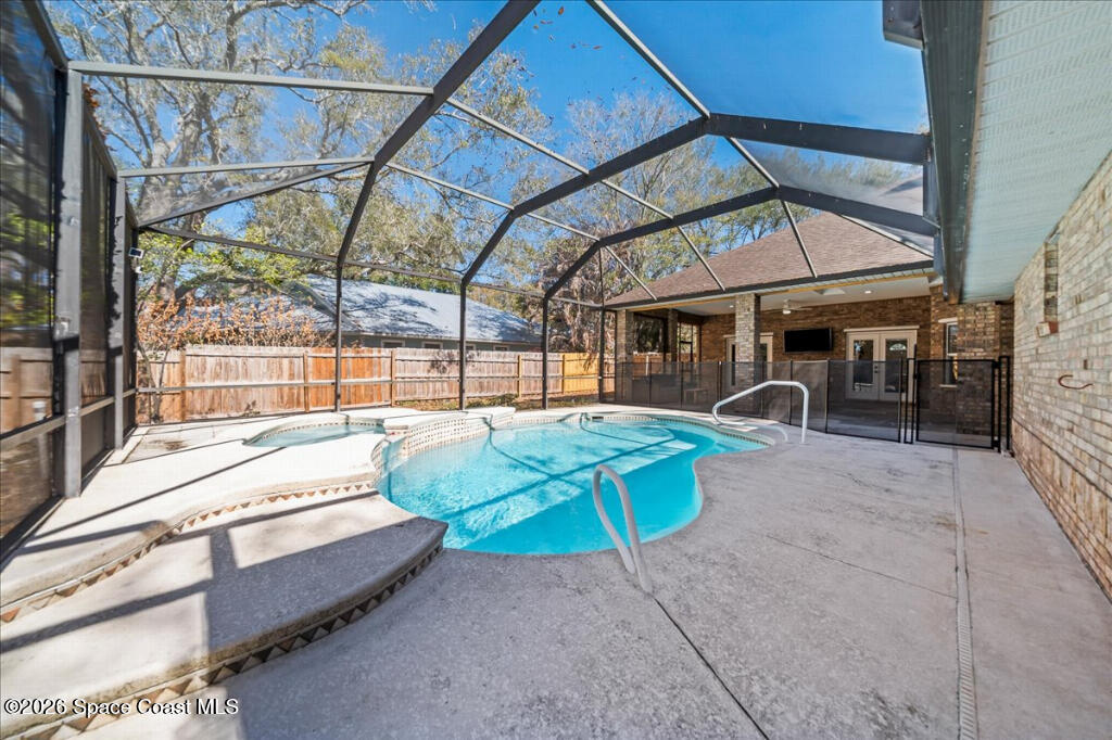 35 River Ridge Drive Rockledge, FL 32955 - Photo 30 of 48 a view of backyard with a table and chairs under an umbrella