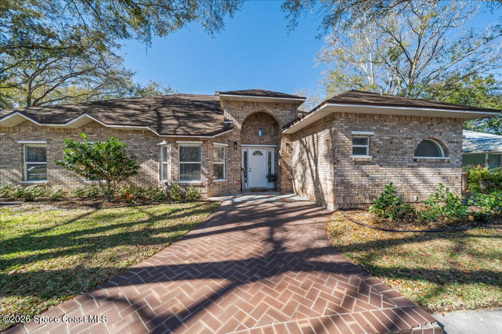 35 River Ridge Drive Rockledge, FL 32955 - Photo 3 of 48 a front view of a house with a garden