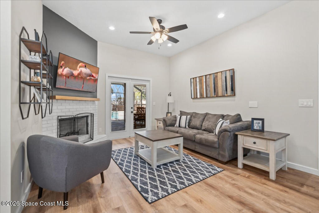 35 River Ridge Drive Rockledge, FL 32955 - Photo 6 of 48 a living room with furniture a flat screen tv and a fireplace