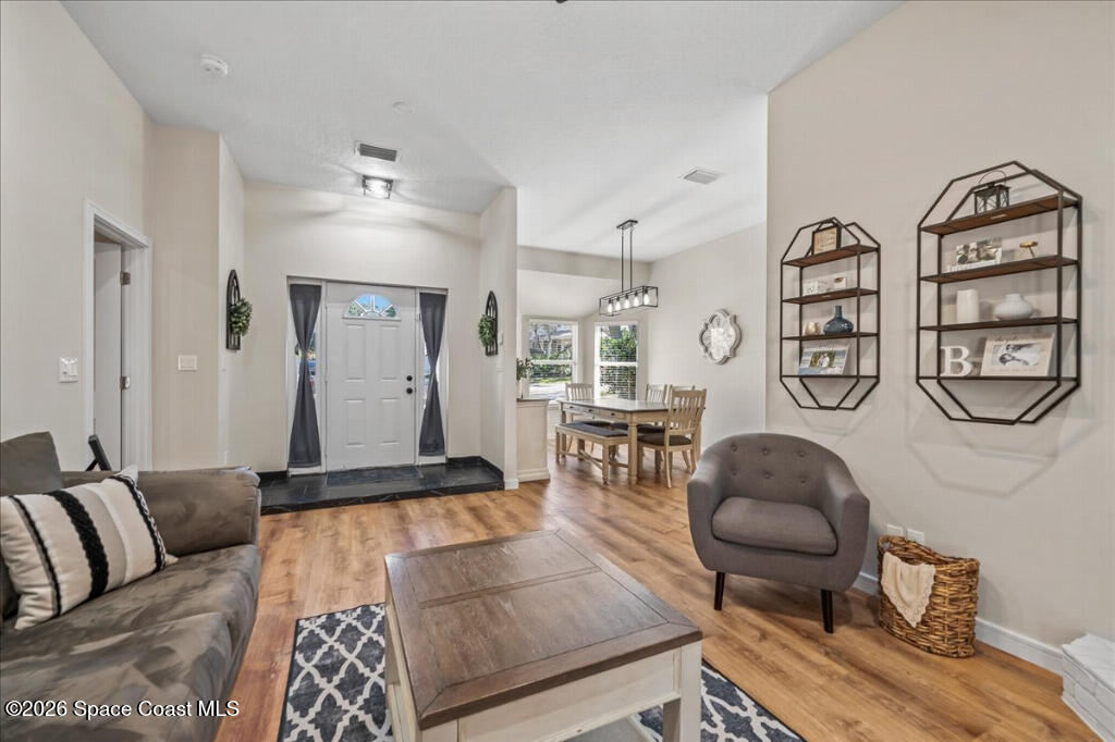 35 River Ridge Drive Rockledge, FL 32955 - Photo 7 of 48 a living room with furniture and wooden floor