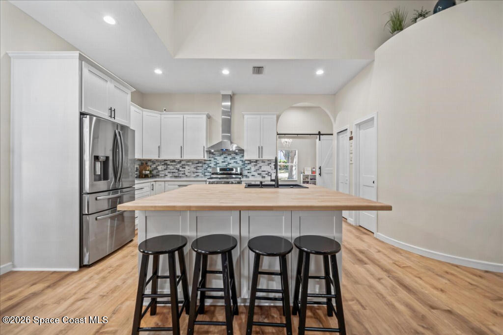 35 River Ridge Drive Rockledge, FL 32955 - Photo 9 of 48 a kitchen with refrigerator a sink and chairs