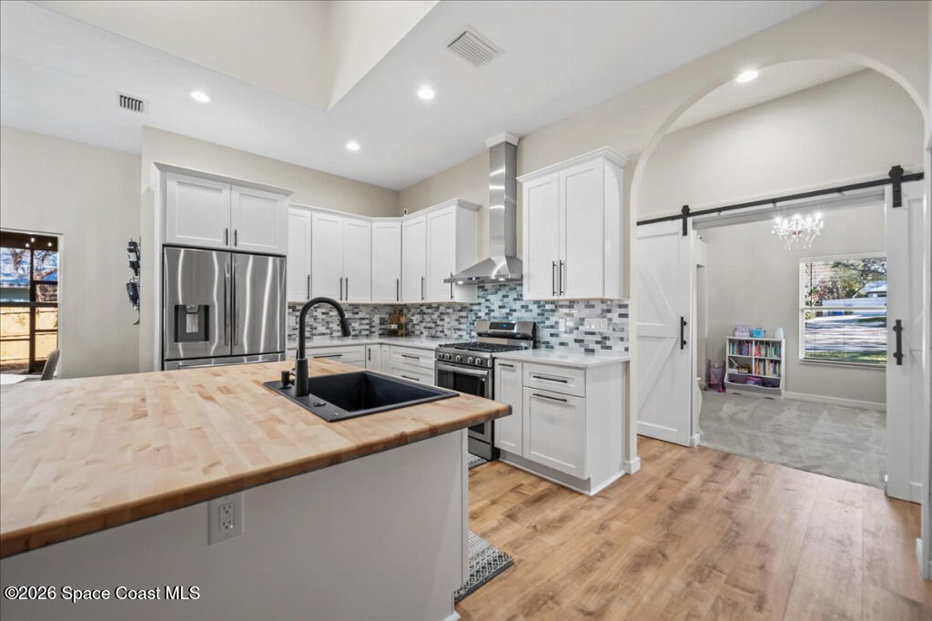 35 River Ridge Drive Rockledge, FL 32955 - Photo 10 of 48 a kitchen with a refrigerator and a sink
