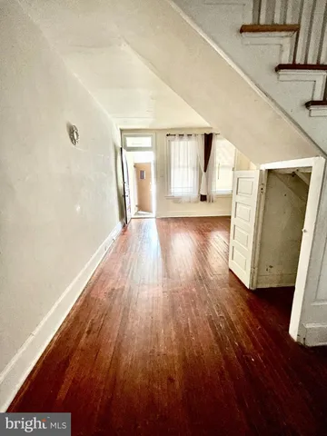 a view of a room with wooden floor and staircase