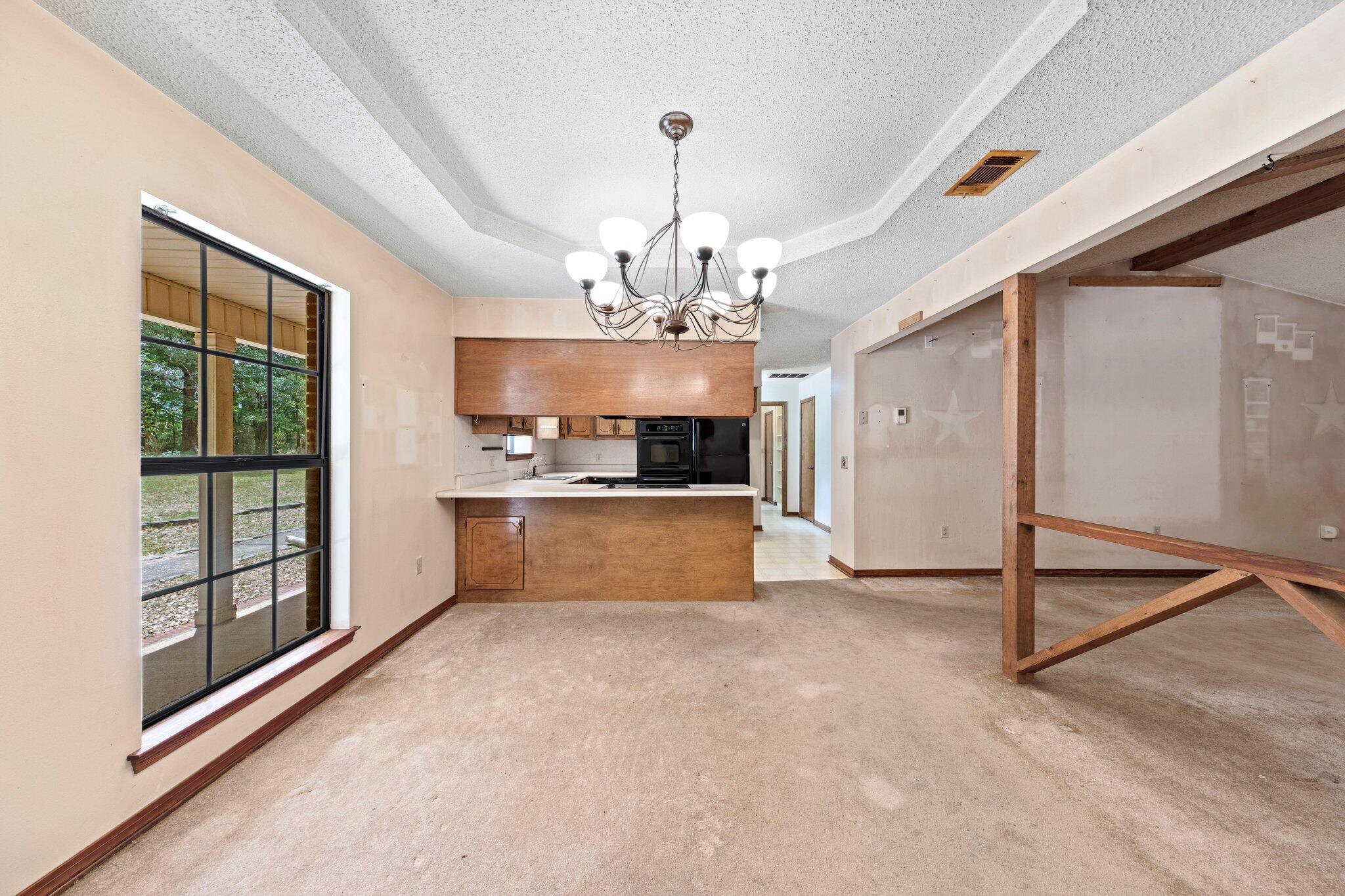 6709 Old River Road Baker, FL 32531 - Photo 6 of 43 a view of a kitchen with granite countertop a refrigerator and a sink