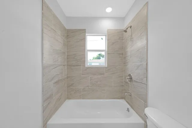 a bath tub sitting next to a white sink