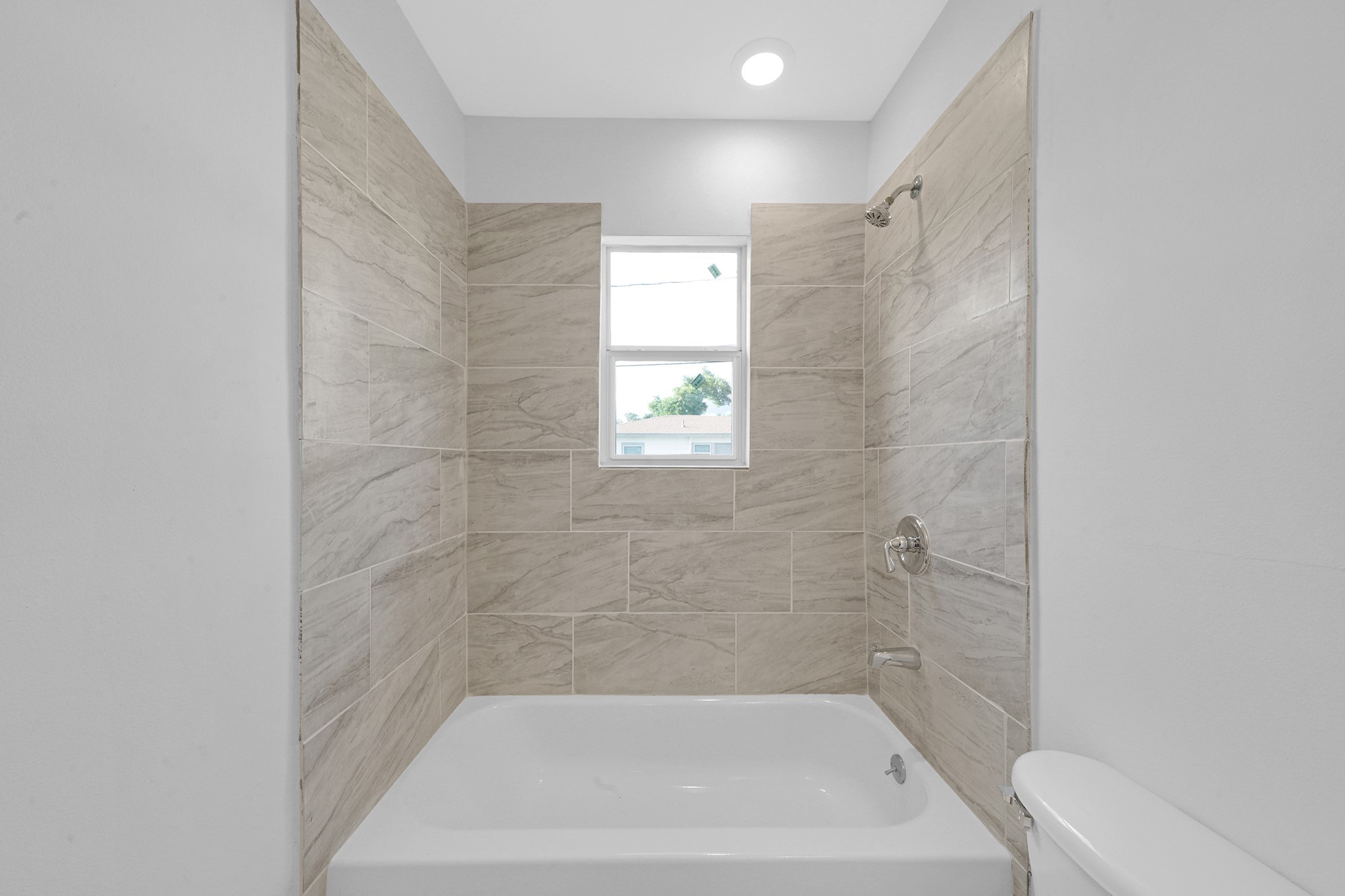 1753 West 6th Street Freeport, TX 77541 - Photo 12 of 20 a bath tub sitting next to a white sink