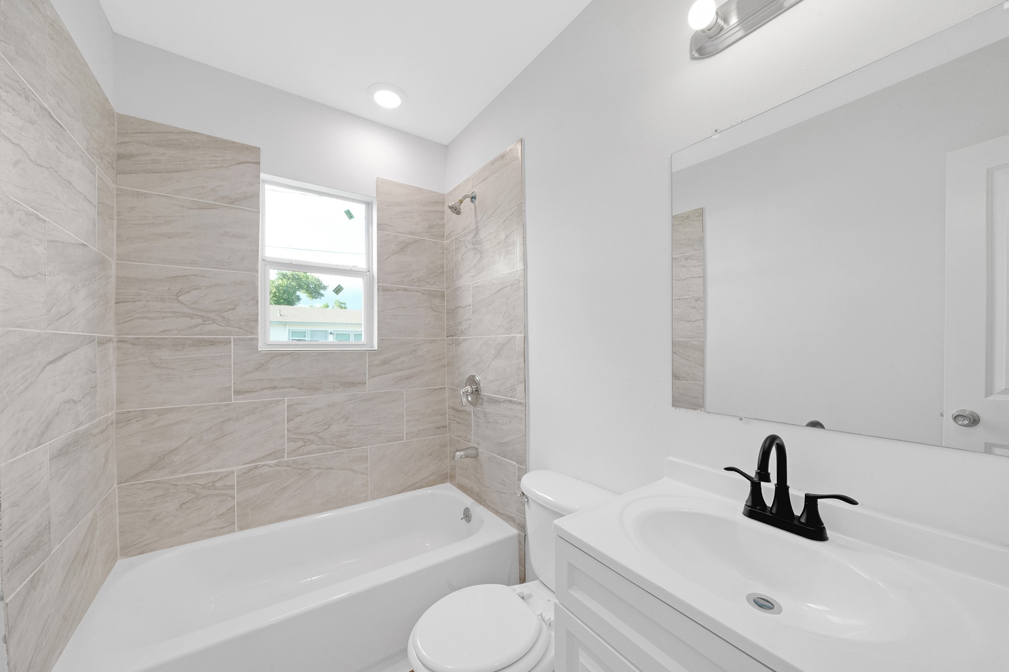 1753 West 6th Street Freeport, TX 77541 - Photo 13 of 20 a bathroom with a sink a toilet and bathtub