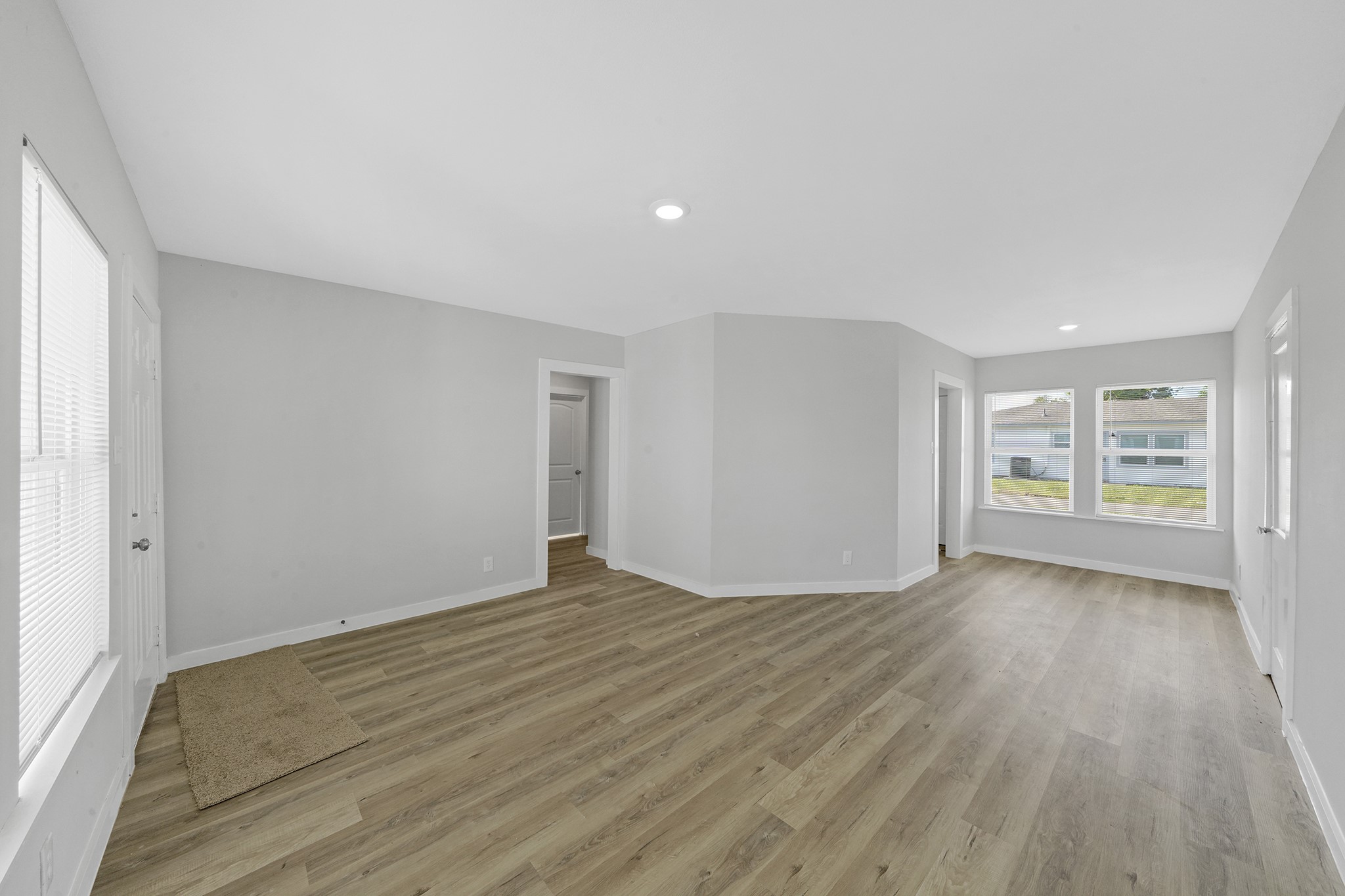 1753 West 6th Street Freeport, TX 77541 - Photo 15 of 20 a view of an empty room with wooden floor and a window